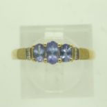Modern 14ct gold ring set with blue topaz and diamonds, size P, 2.3g. P&P Group 0 (£6+VAT for the
