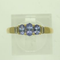 Modern 14ct gold ring set with blue topaz and diamonds, size P, 2.3g. P&P Group 0 (£6+VAT for the
