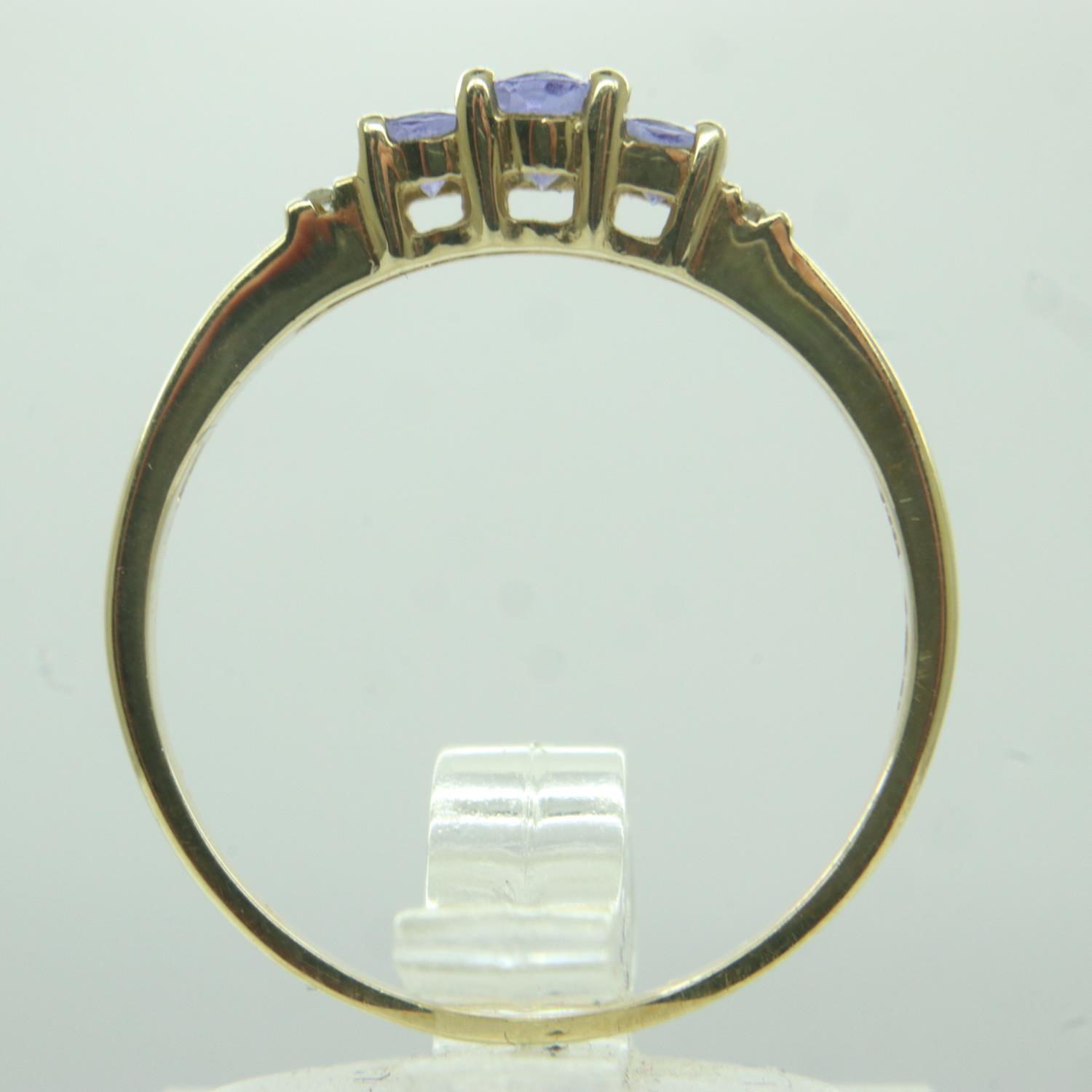 Modern 14ct gold ring set with blue topaz and diamonds, size P, 2.3g. P&P Group 0 (£6+VAT for the - Image 2 of 3