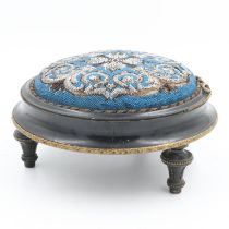 Victorian beadwork circular footstool, having an ebonised brass mounted frame, D: 30 cm. UK P&P