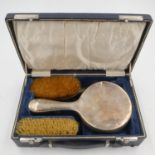 Hallmarked silver vanity set comprising brushes and a mirror in a case, mirror with damage. UK P&P