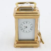 Miniature brass carriage clock with white enamel dial, H: 80 mm. UK P&P Group 1 (£16+VAT for the