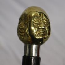 Brass four faced Buddha handled walking stick, L: 96 cm. UK P&P Group 2 (£20+VAT for the first lot