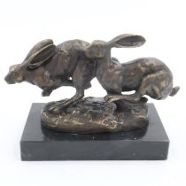 Bronze running hares on marble base, signed Nick, L: 13 cm. UK P&P Group 2 (£20+VAT for the first