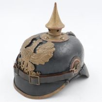 WWI 1895 model Imperial German pickelhaube with chinstrap and cockades. unit marked to the 70th