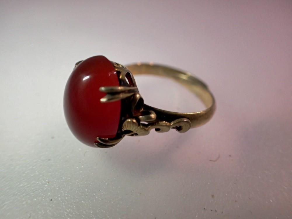 A silver-gilt dress ring set with a large cabochon carnelian. UK P&P Group 0 (£6+VAT for the first