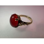 A silver-gilt dress ring set with a large cabochon carnelian. UK P&P Group 0 (£6+VAT for the first