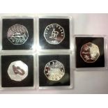 Five 50p commemorative coins in Quadrium cases. UK P&P Group 0 (£6+VAT for the first lot and £1+