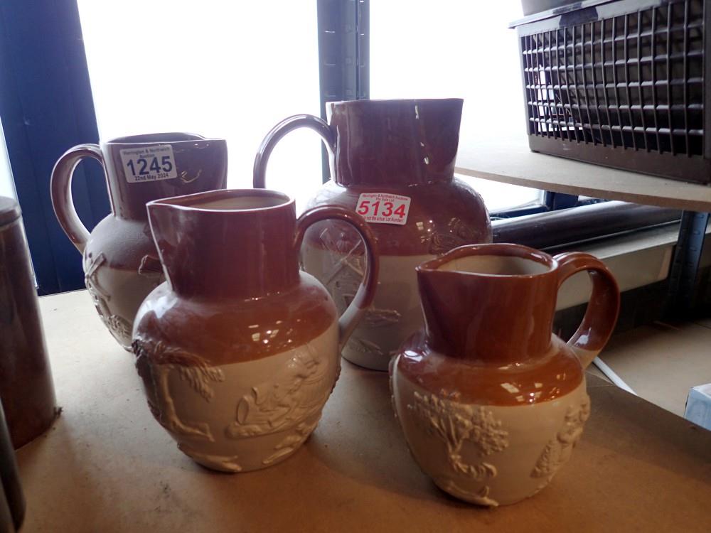 Four graduated stoneware jugs. Not available for in-house P&P