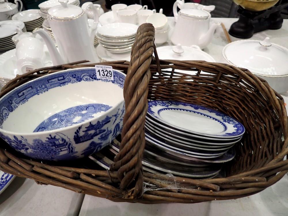 Wicker basket containing mixed blue and white ceramics. Not available for in-house P&P