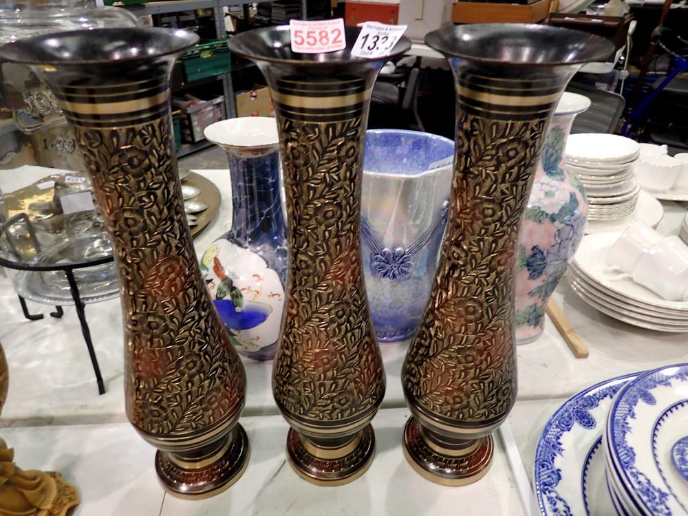 Three brass floral etched vases, H: 45 cm. This lot is offered for sale on behalf The Brabners