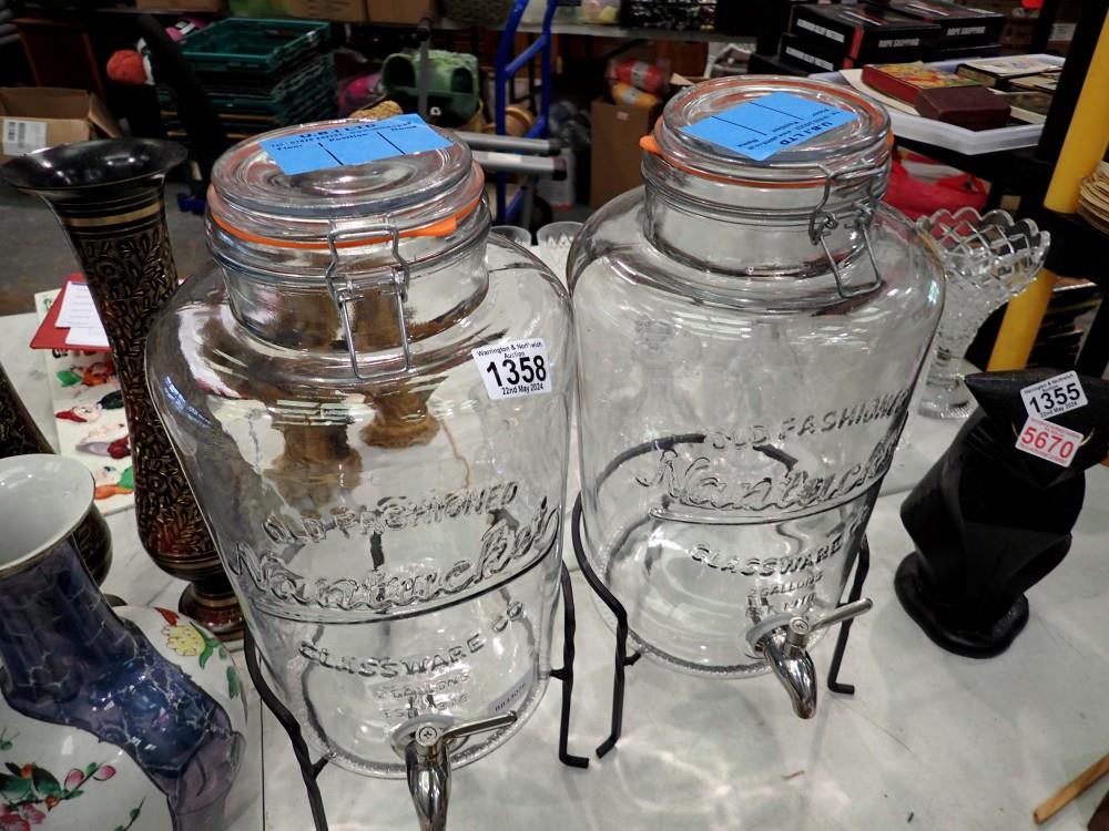 Two Nantucket two gallon punch barrels on metal stands. This lot is offered for sale on behalf The