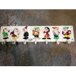 Cast iron seven dwarves cup rack, L: 60cm. UK P&P Group 3 (£30+VAT for the first lot and £8+VAT