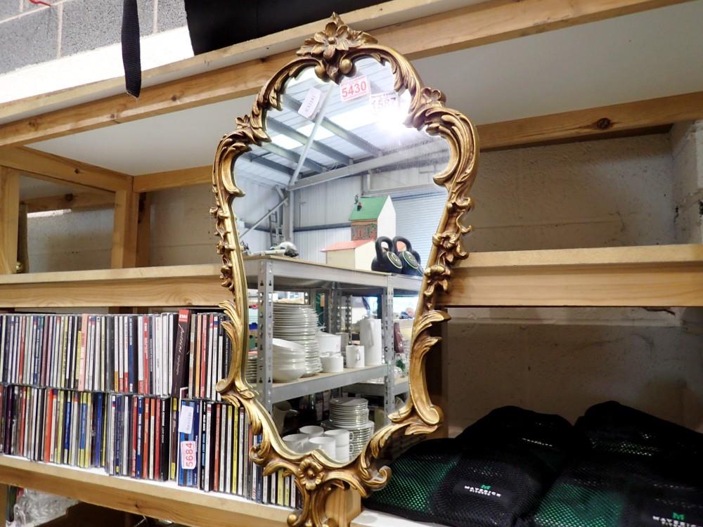 Gilt framed shaped mirror, H: 66 cm, L: 37 cm. Not available for in-house P&P