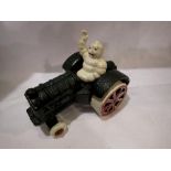 Cast iron Michellin Man on a tractor. H:80mm. UK P&P Group 1 (£16+VAT for the first lot and £2+VAT