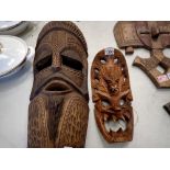 Two carved wooden Tribal masks. Not available for in-house P&P