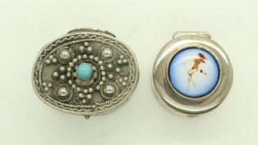 Two silver pill boxes, one set with an enamelled panel depicting a reclining nude, combined 27g.