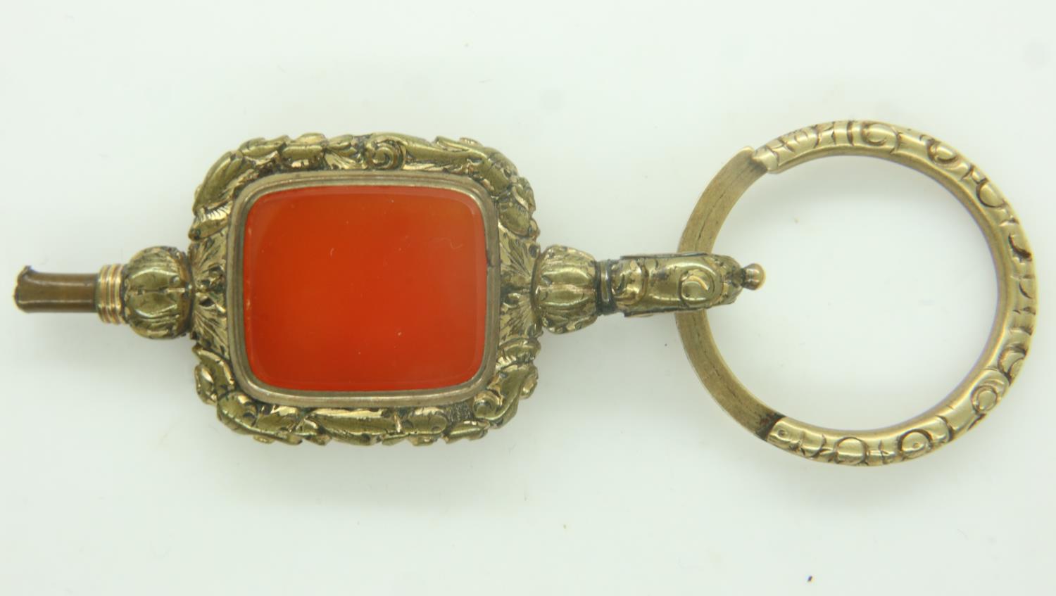 A 19th century over-sized gilt-metal pocket watch key, set with a panel of agate. P&P Group 0 (£6+