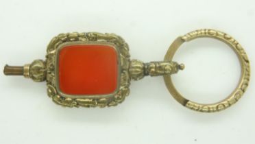 A 19th century over-sized gilt-metal pocket watch key, set with a panel of agate. P&P Group 0 (£6+