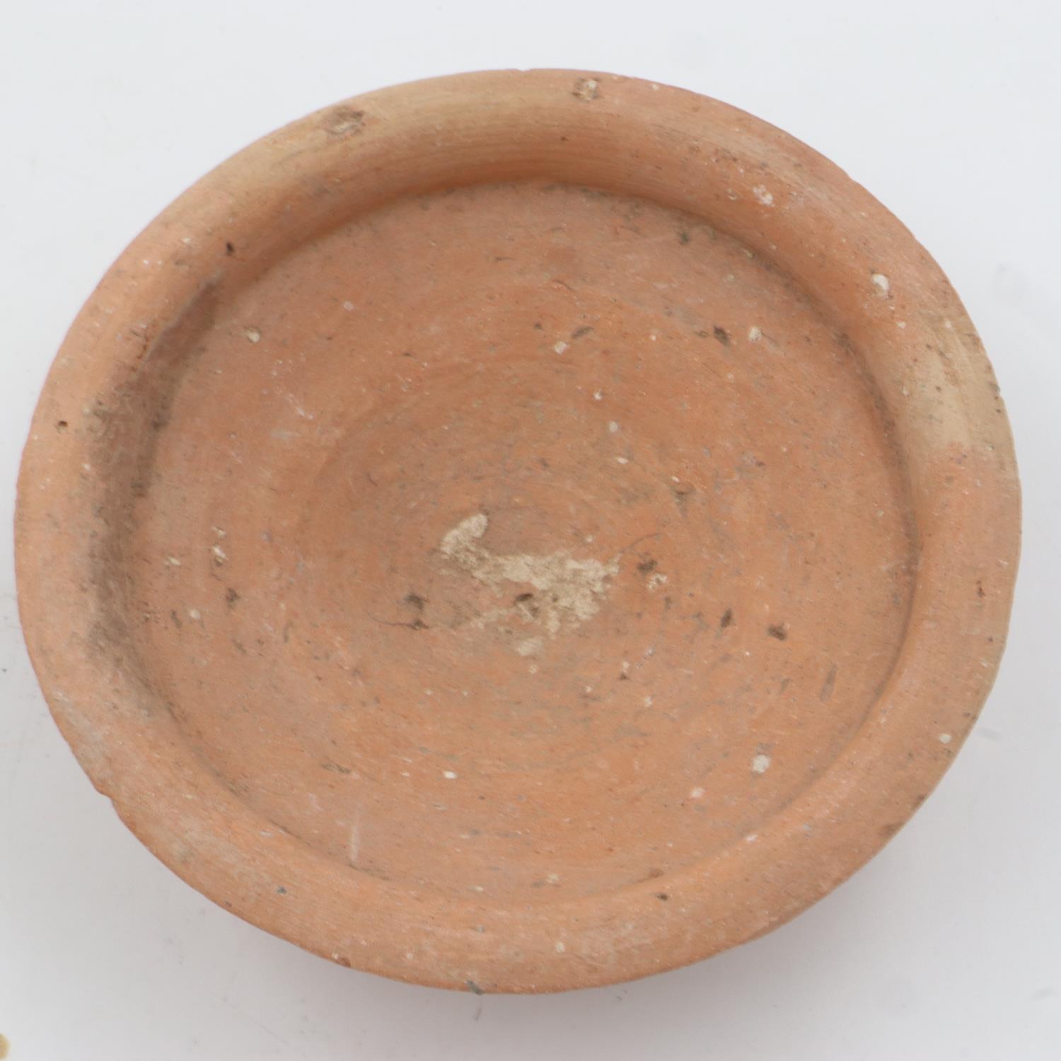 An early Han period terracotta footed bowl, collection number written to underside, D: 12 cm. UK P&P