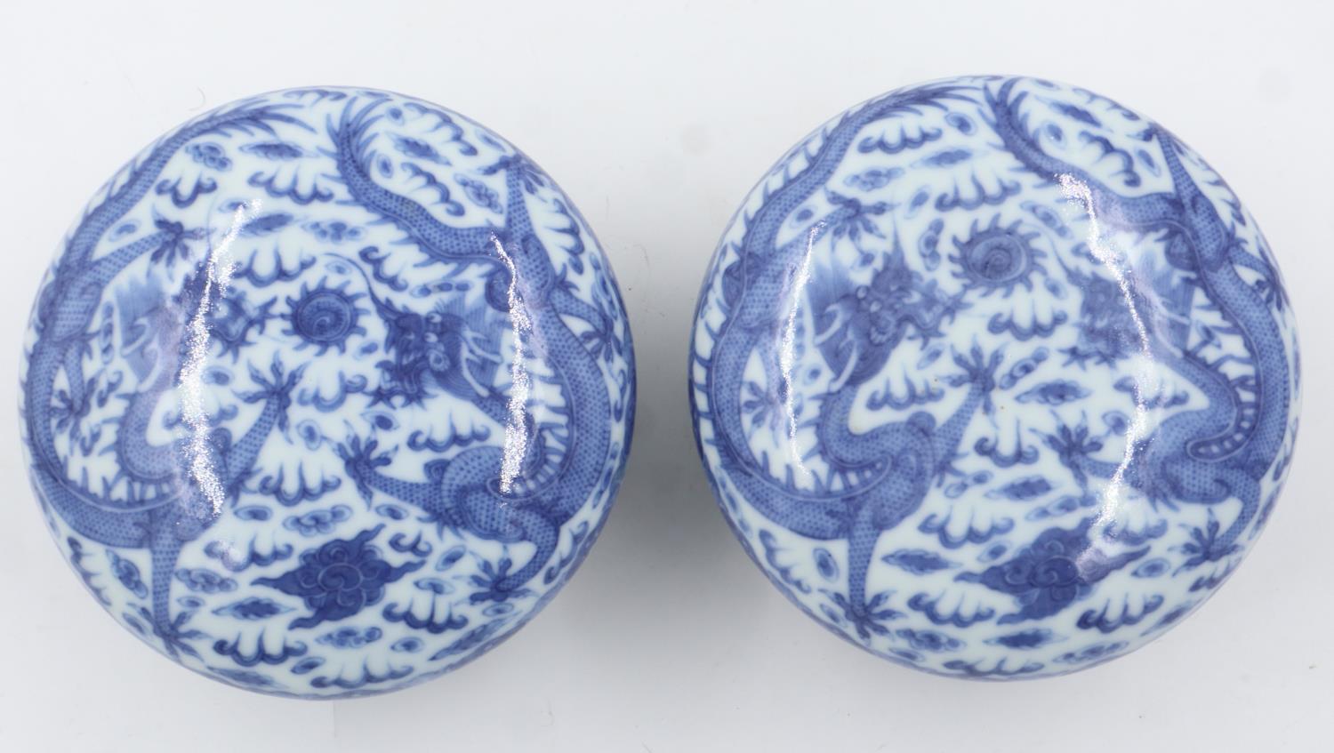 Pair of Chinese blue and white covered bowls with dragon decoration, each raised on a wooden - Image 2 of 6