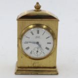 Miniature mechanical brass table clock, H: 80 mm. UK P&P Group 2 (£20+VAT for the first lot and £4+