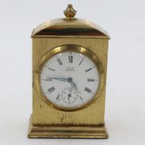 Miniature mechanical brass table clock, H: 80 mm. UK P&P Group 2 (£20+VAT for the first lot and £4+
