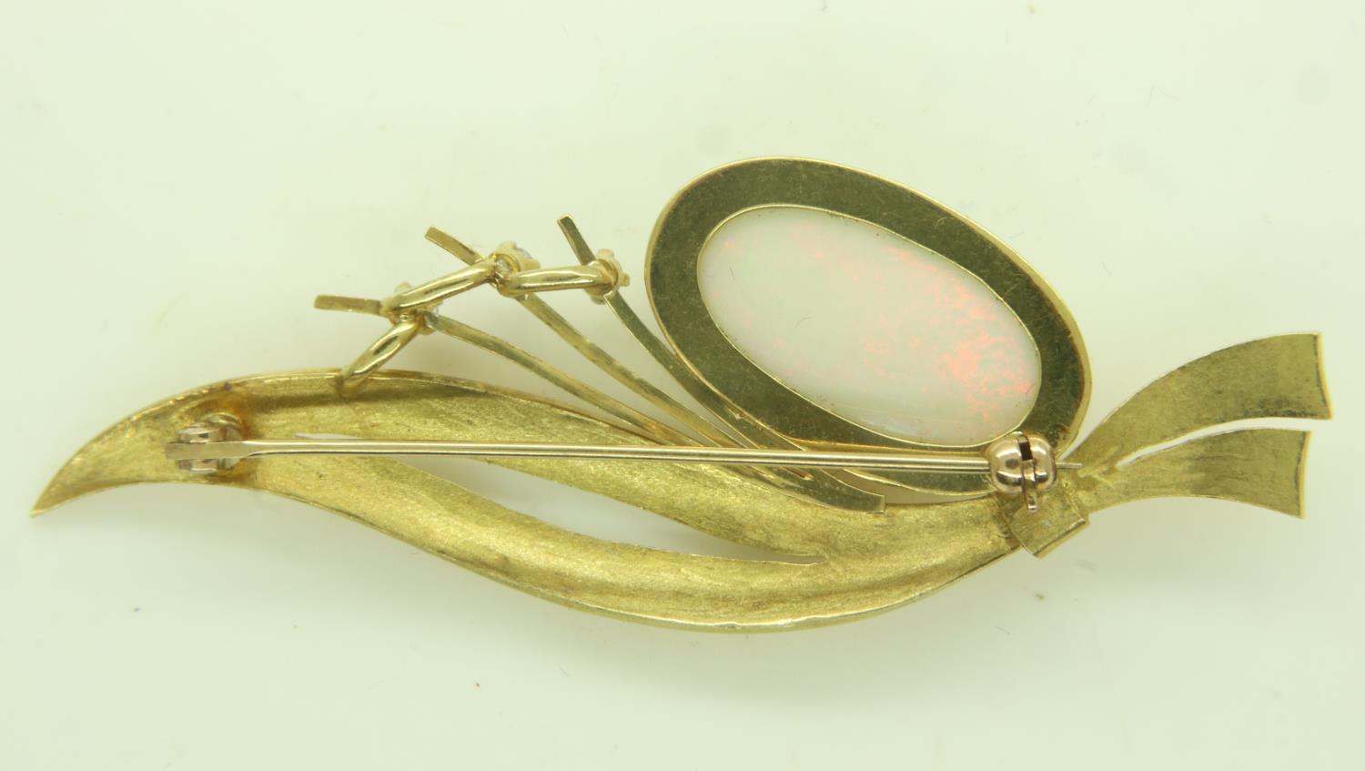 Continental gold brooch (unmarked), set with a large oval cabochon opal and three diamonds, L: 65 - Image 2 of 2