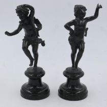 A pair of bronze putti figures, unsigned, raised on marble socle bases, each H: 24 cm. UK P&P