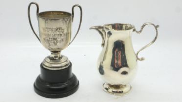 Hallmarked silver cream jug and a miniature silver trophy, combined 117g. UK P&P Group 1 (£16+VAT