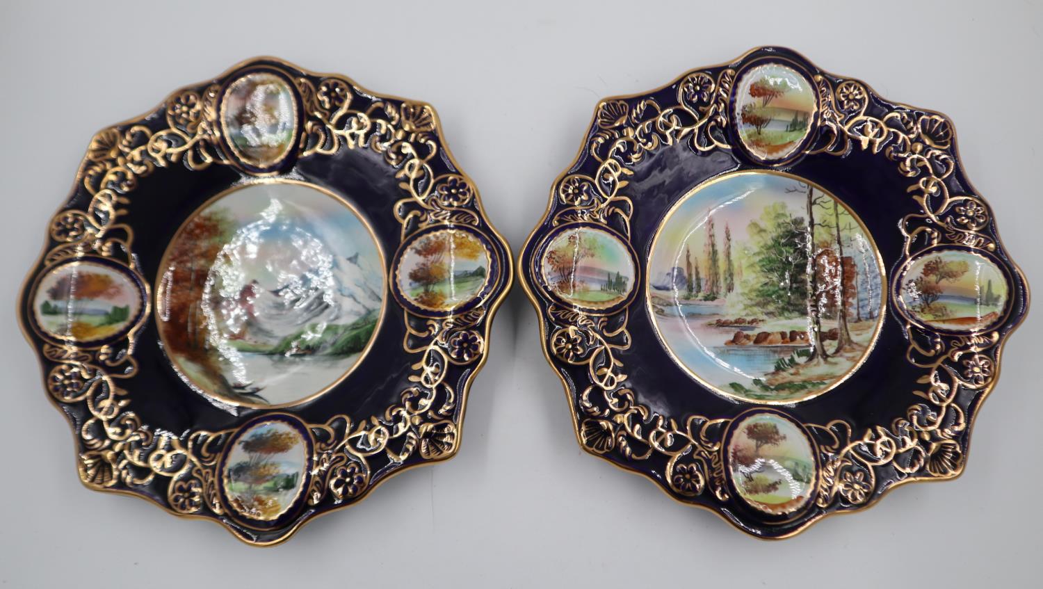 A pair of Portuguese cabinet plates, each gilt and displaying a large painted bowl surrounded by