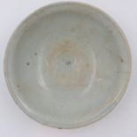 A celadon glazed porcelain bowl having incised decoration to its interior and a footed base, D: 17