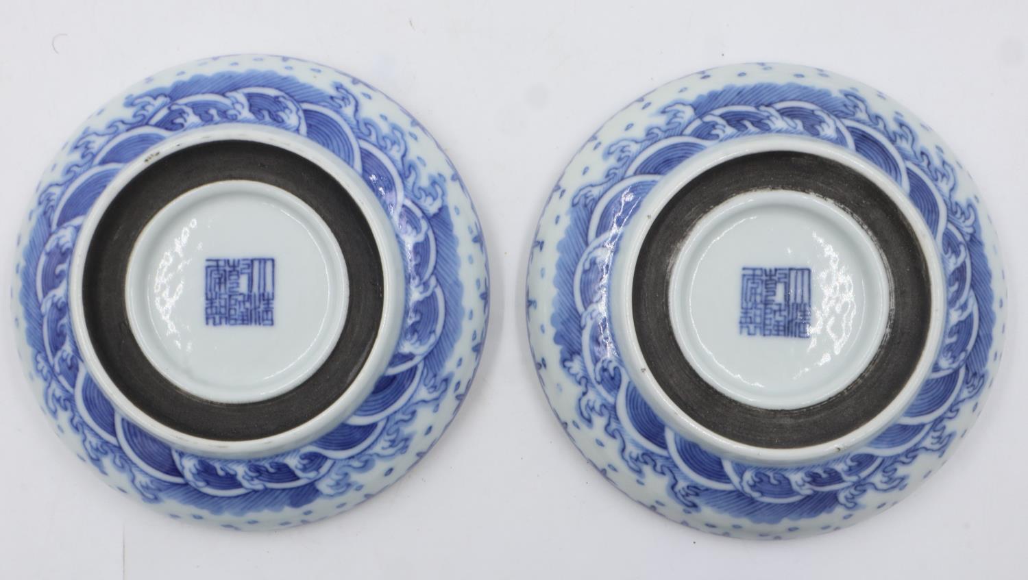 Pair of Chinese blue and white covered bowls with dragon decoration, each raised on a wooden - Image 4 of 6