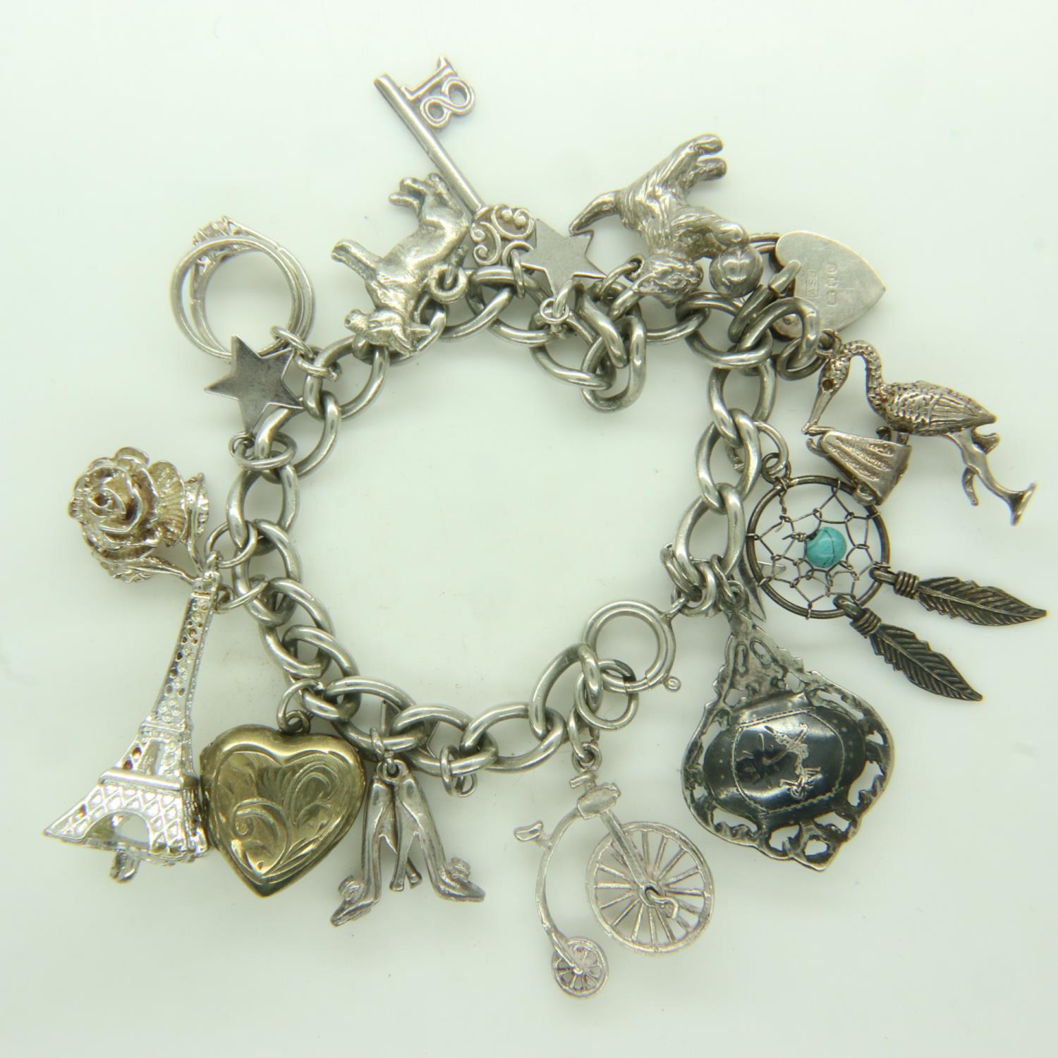 925 silver charm bracelet with seventeen charms, L: 21 cm, 47g. UK P&P Group 0 (£6+VAT for the first
