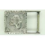 A white metal buckle, decorated in relief with an image of Aries, stamped verso (indistinct). UK P&P