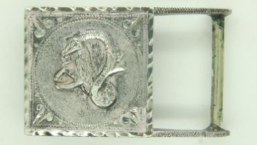 A white metal buckle, decorated in relief with an image of Aries, stamped verso (indistinct). UK P&P