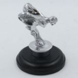 Chrome flying lady on a wooden base, H: 14 cm. UK P&P Group 2 (£20+VAT for the first lot and £4+