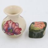 Moorcroft trinket box in the hibiscus pattern and a Moorcroft vase in the magnolia pattern,