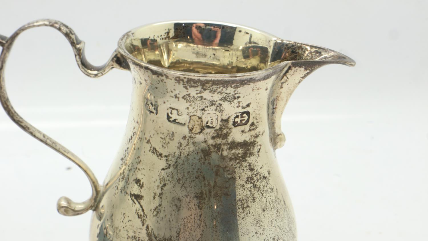 Hallmarked silver cream jug and a miniature silver trophy, combined 117g. UK P&P Group 1 (£16+VAT - Image 2 of 3