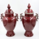 A pair of large Sang De Boeuf ceramic temple urns, one cover with repair, each H: 60 cm. Not
