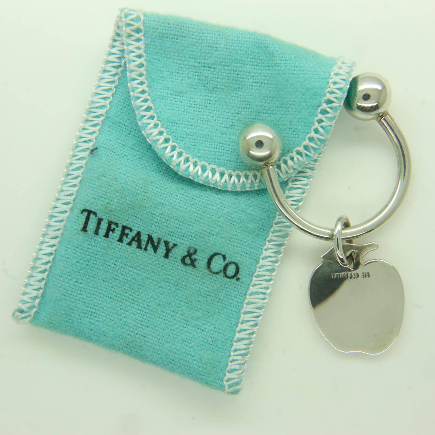 Tiffany & Co silver torq-form keyring with apple charm, in Tiffany fabric pouch, 10g. UK P&P Group 0