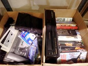 Two boxes of mixed electrical items to include video recorder and videos. Not available for in-house
