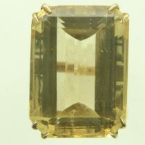 An 18ct gold solitaire ring, set with an oversized faceted citrine in a pierced raised setting, size