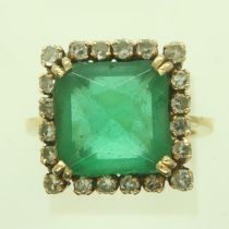 A continental gold cocktail ring, set with a large princess-cut emerald surrounded by twenty