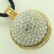 SWAROVSKI: an oversized globular stone-set pendant on a black nylon rope, pendant drop L: 40 mm.