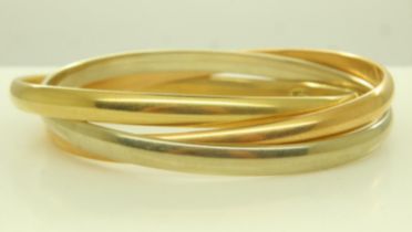 An 18ct tri-gold suite of three interlocking bangles, each D: 70 mm, 46.4g. UK P&P Group 1 (£16+