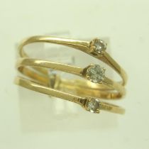 A continental gold suite of three rings, attached to form a trilogy ring, each set with diamond,