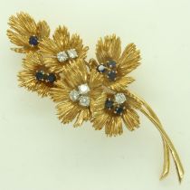BOUCHERON (Paris): an 18ct gold brooch, floral design set with diamonds and sapphires, twin-pin,