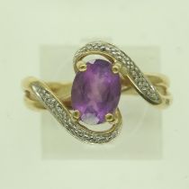 9ct gold amethyst and diamond crossover ring, size P, 3.4g. UK P&P Group 0 (£6+VAT for the first lot