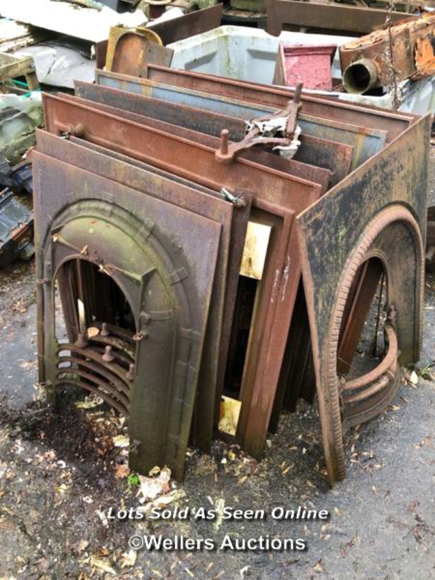 ELEVEN MIXED CAST IRON FIRE PLACE SURROUNDS AND INSERTS